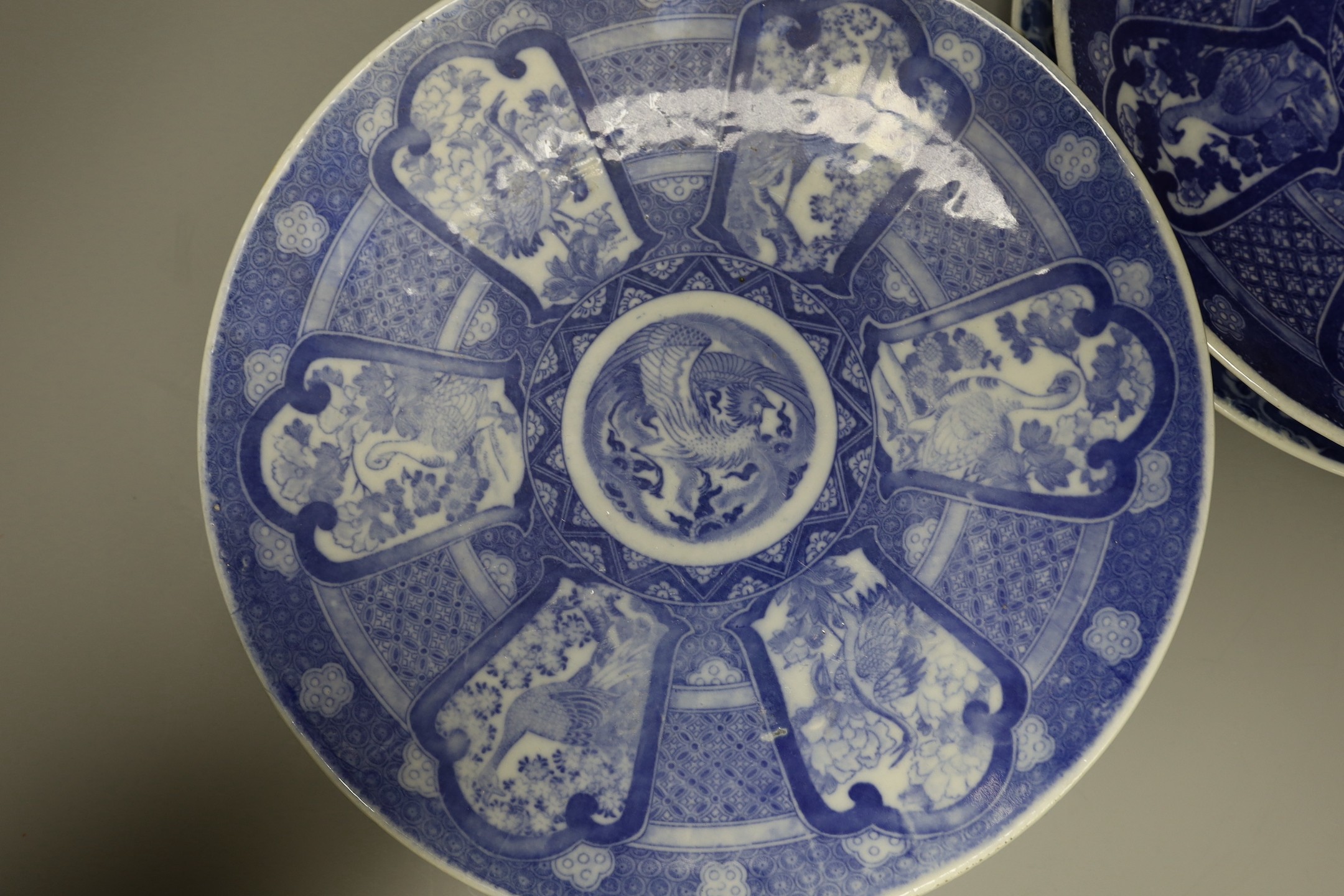 Five early 20th century Japanese blue and white dishes, largest 30.5cm diameter